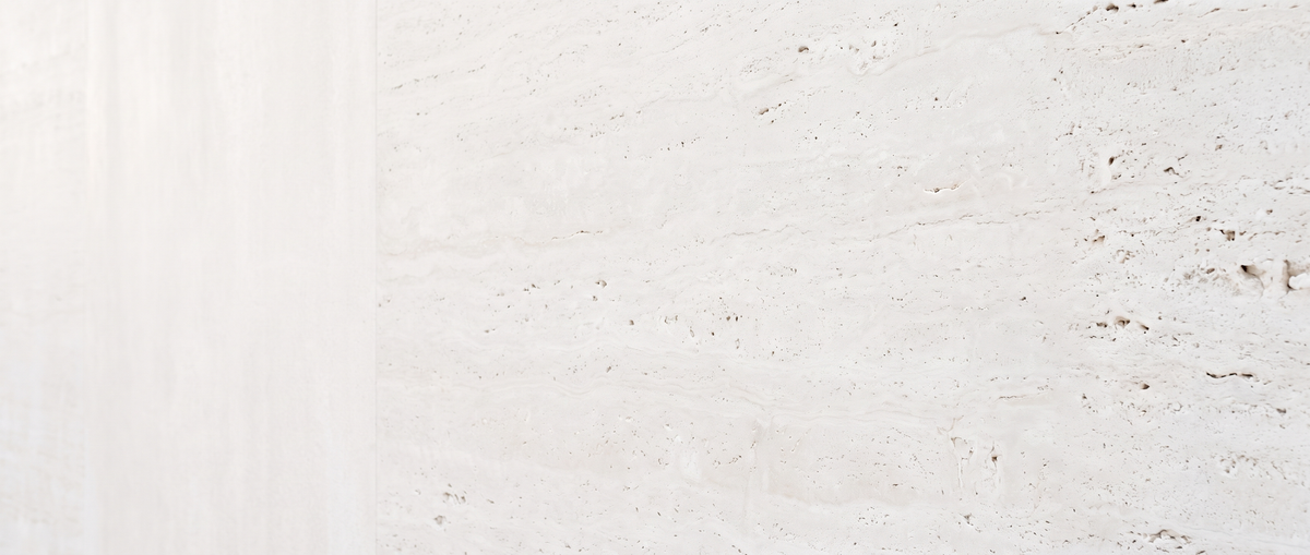 Close view of pale cream travertine stone showing its natural pores and veining