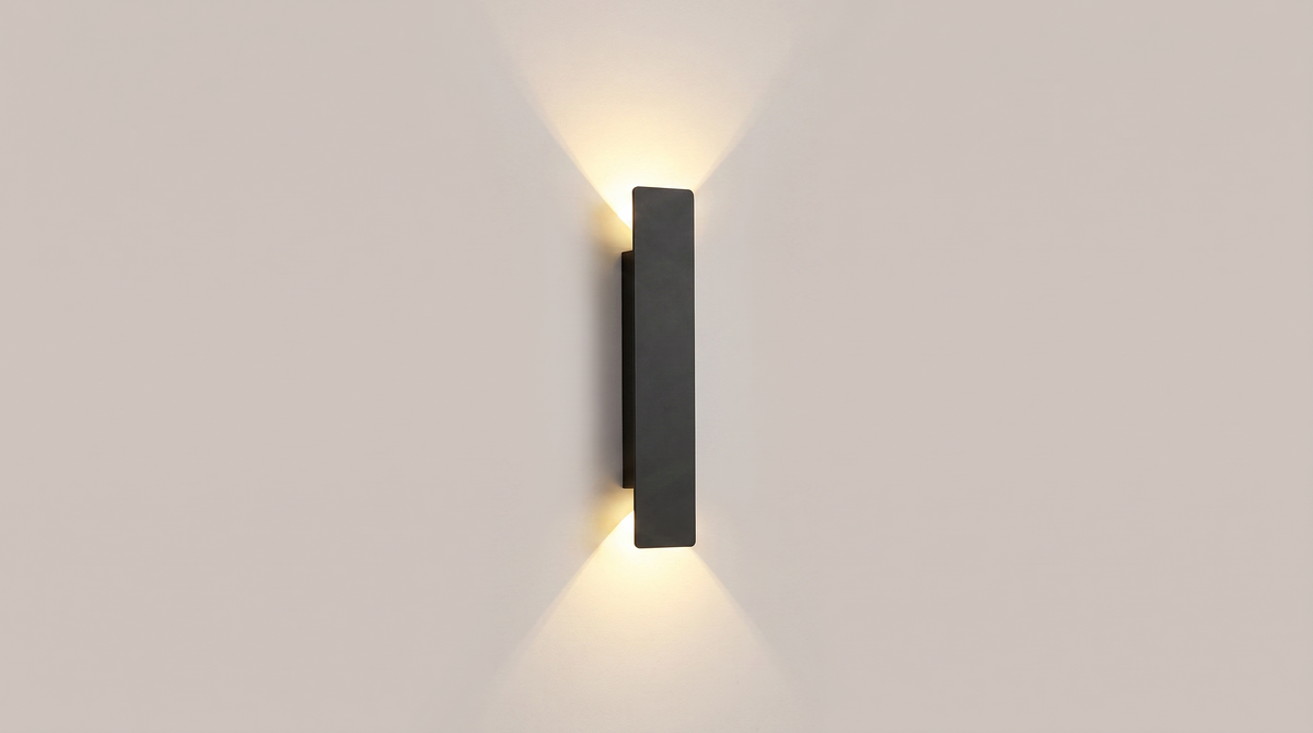 Linea outdoor wall sconce switched on, throwing soft cones of light up and down the wall
