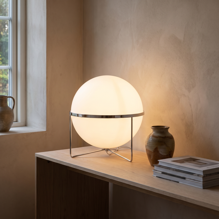 Mira accent lamp lit on a console table in a living room