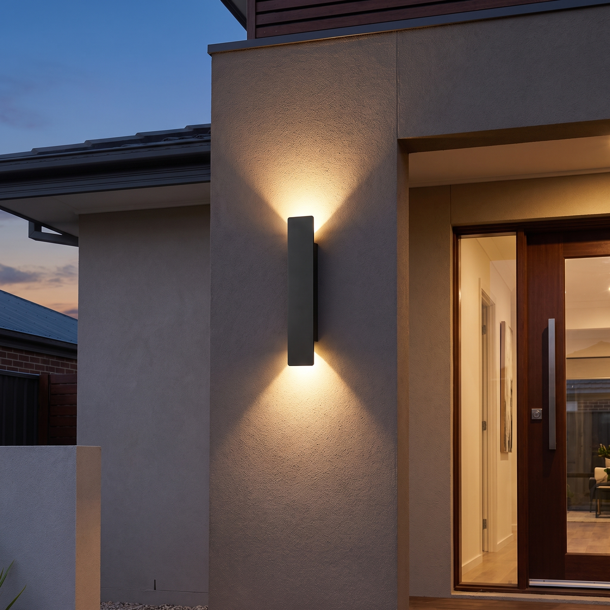 Linea outdoor wall light beside a front door at dusk