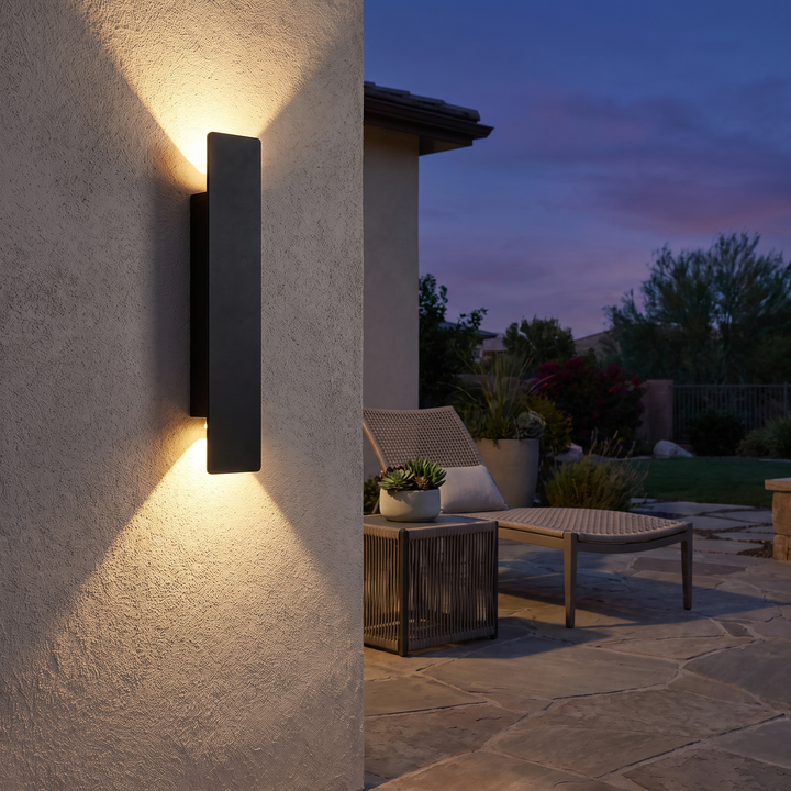 Linea outdoor wall light on a patio wall at dusk