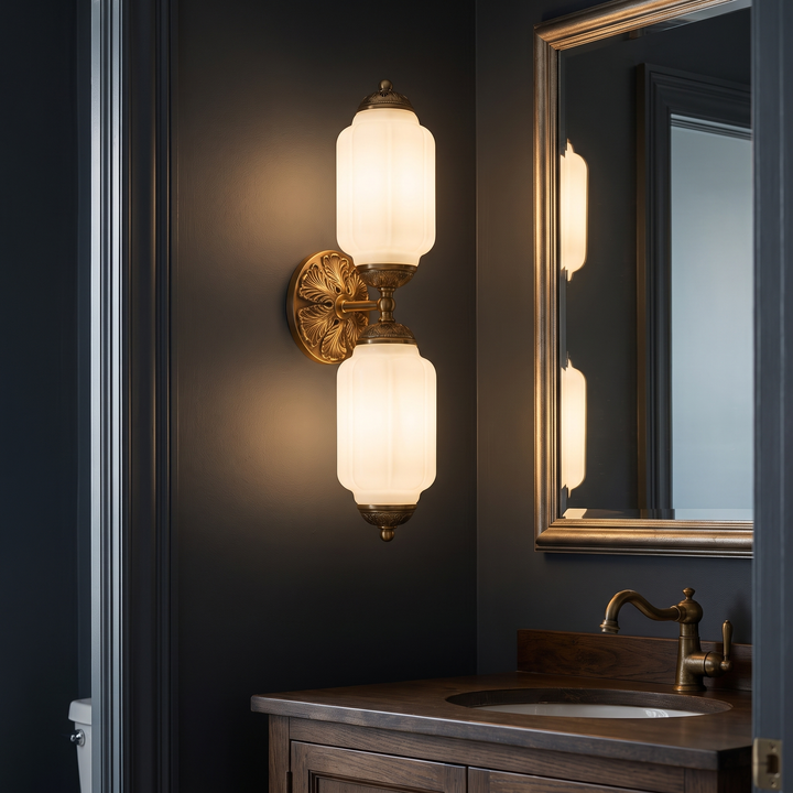 Wren vanity light mounted vertically beside a powder room mirror