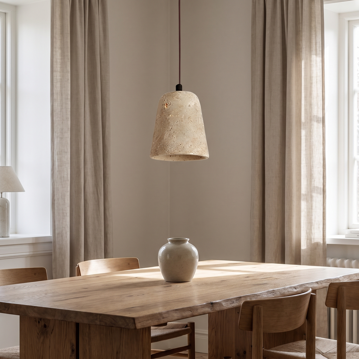 Signe bell pendant above an oak dining table in daylight