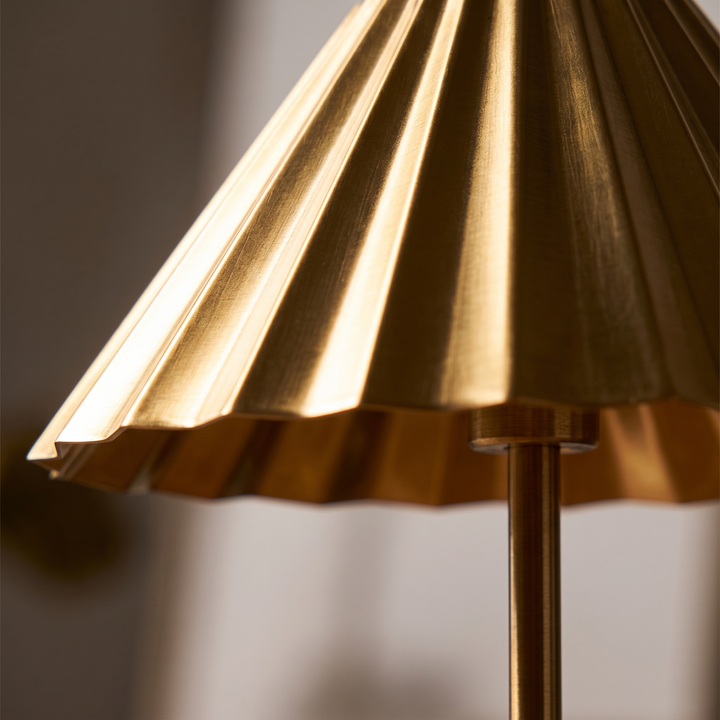 Close view of the pleated brass shade of the Isla lamp