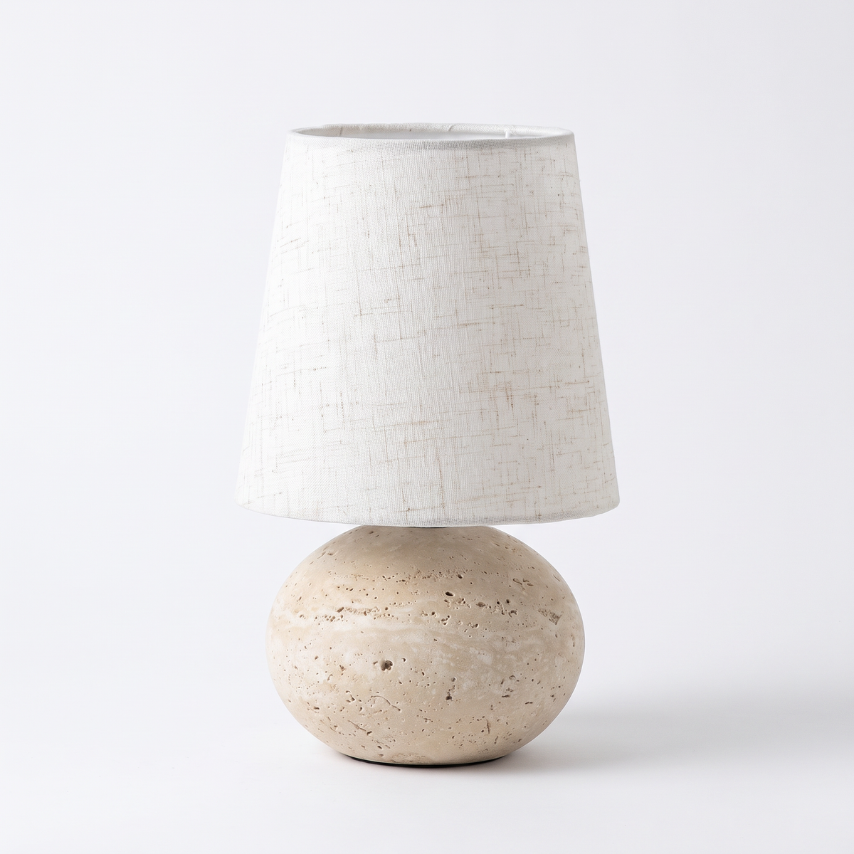 Nella travertine and linen table lamp on a white background