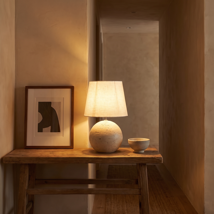 Nella lamp lit on a hallway console table at dusk