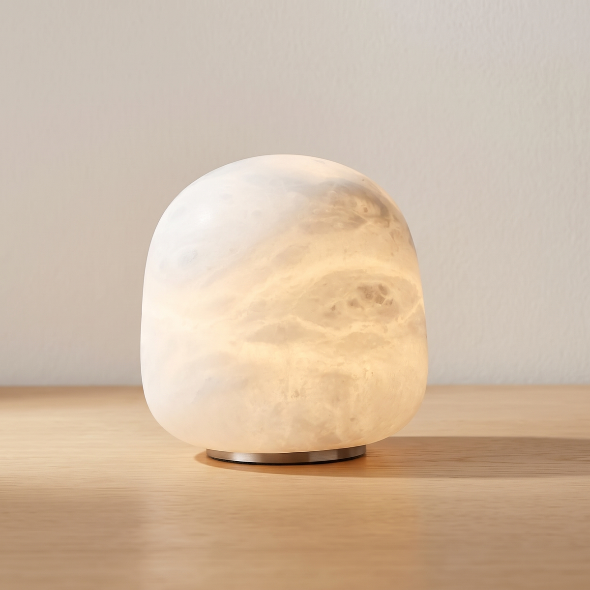 Tove upright cordless alabaster lamp in white on an oak table