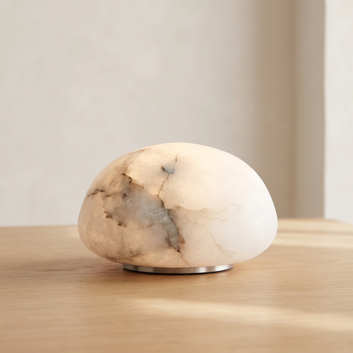 Tove low dome cordless alabaster lamp in white on an oak table