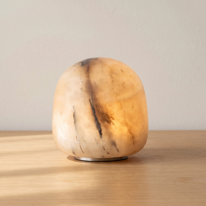Tove upright cordless alabaster lamp in honey on an oak table