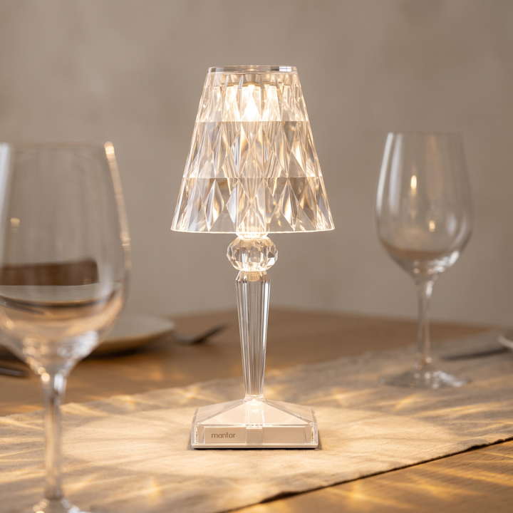 Saga faceted cordless lamp lit on an oak dinner table