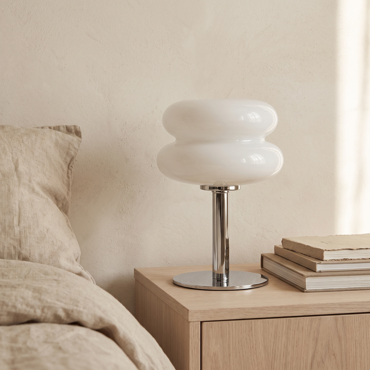 Sylvi white glass dome table lamp on an oak bedside table