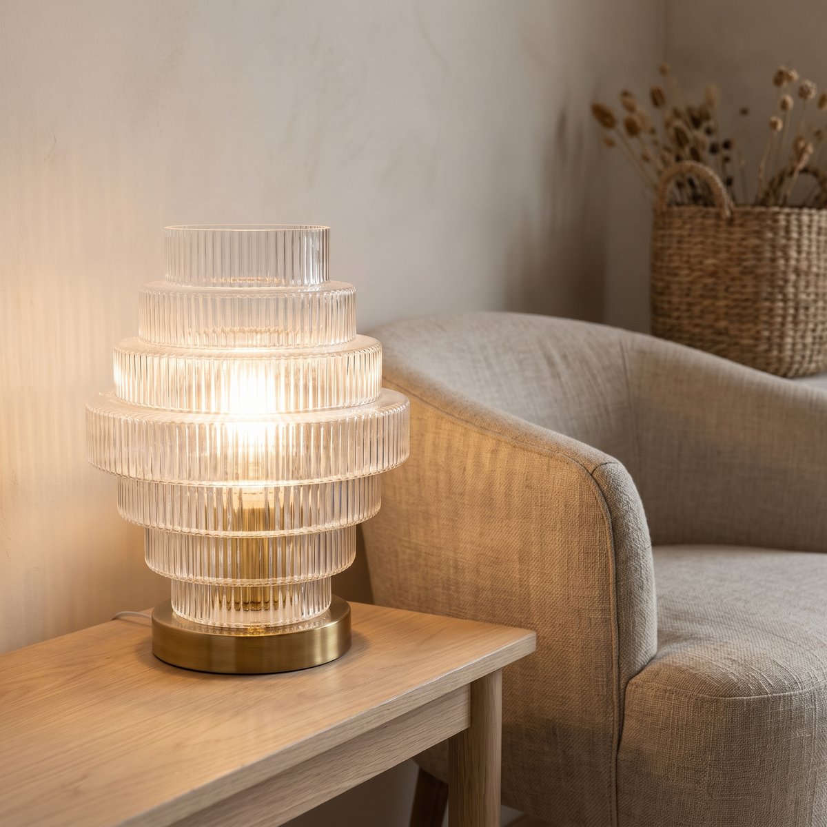 Lova ribbed glass table lamp beside a linen armchair
