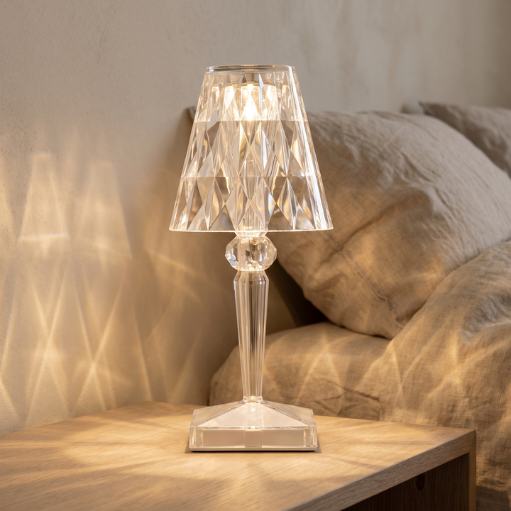 Saga faceted cordless lamp glowing on an oak bedside table