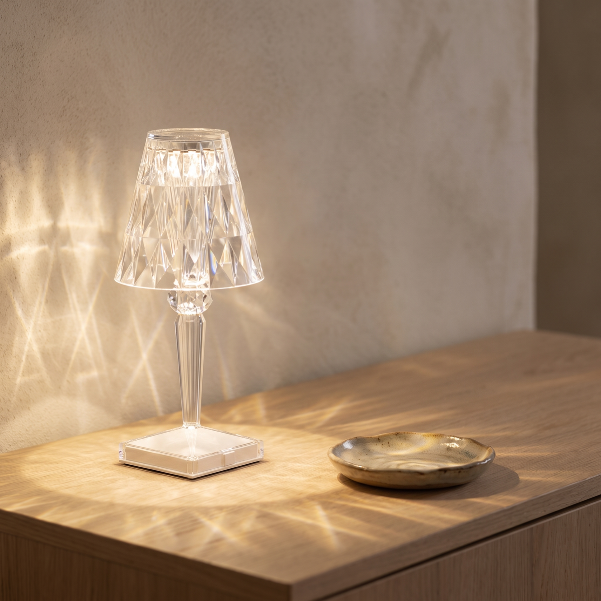 Saga faceted cordless lamp lit on an oak hallway console