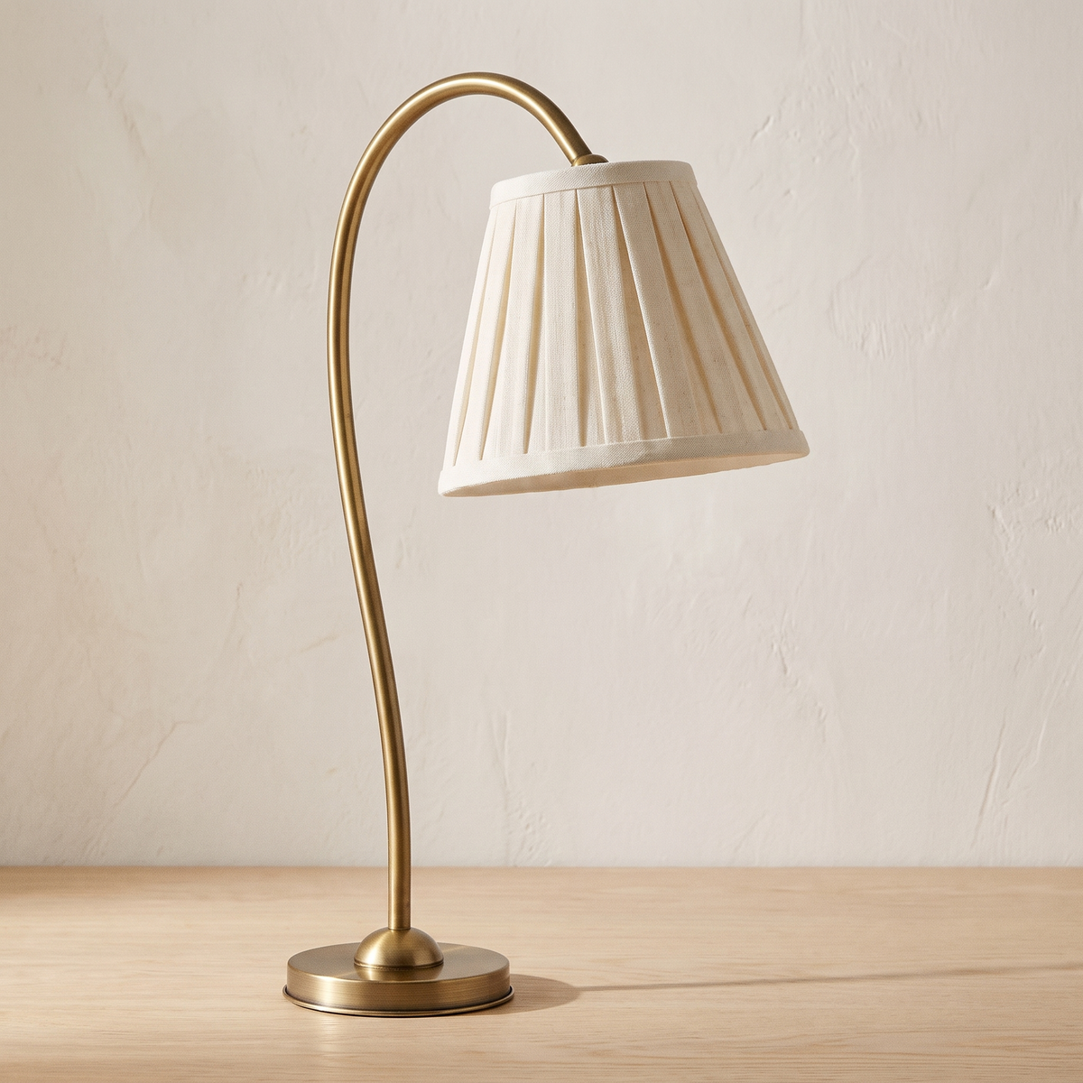 Marit pleated linen shade table lamp with a brass arm