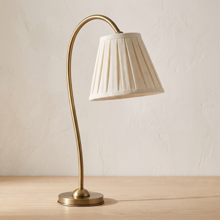Marit pleated linen shade table lamp with a brass arm