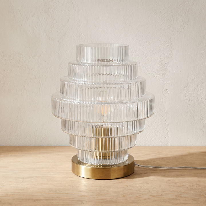 Lova tiered ribbed glass table lamp with a brass base