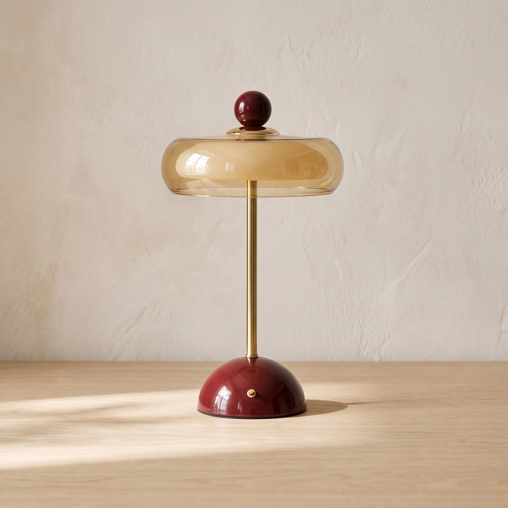 Runa cordless glass disc table lamp with a deep red base