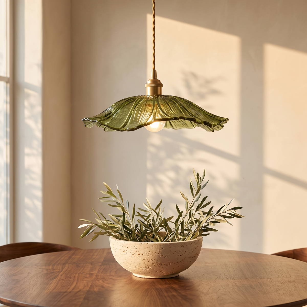 Ninfea pendant above a round table with an olive branch bowl