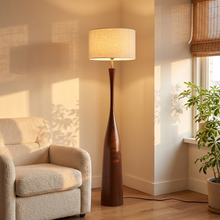 Morella floor lamp in a living room corner beside a boucle armchair