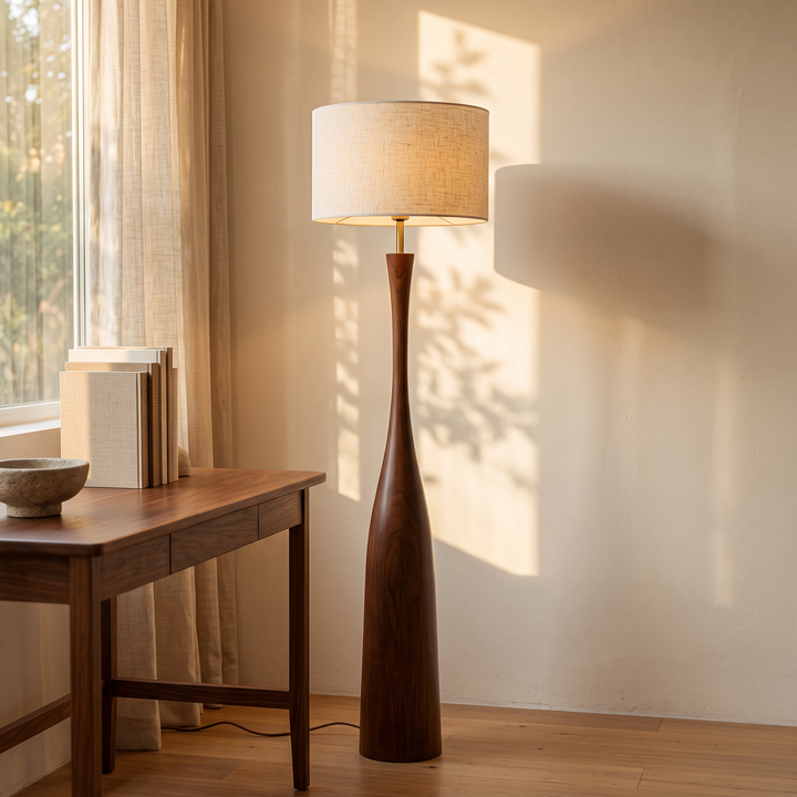 Morella floor lamp beside a walnut writing desk