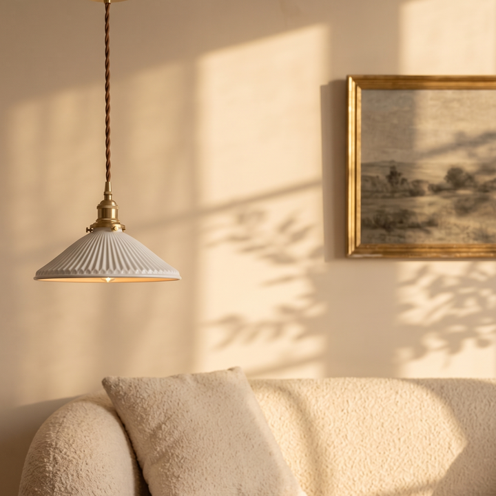 Bellora Cone pendant light in a living room above a cream boucle sofa