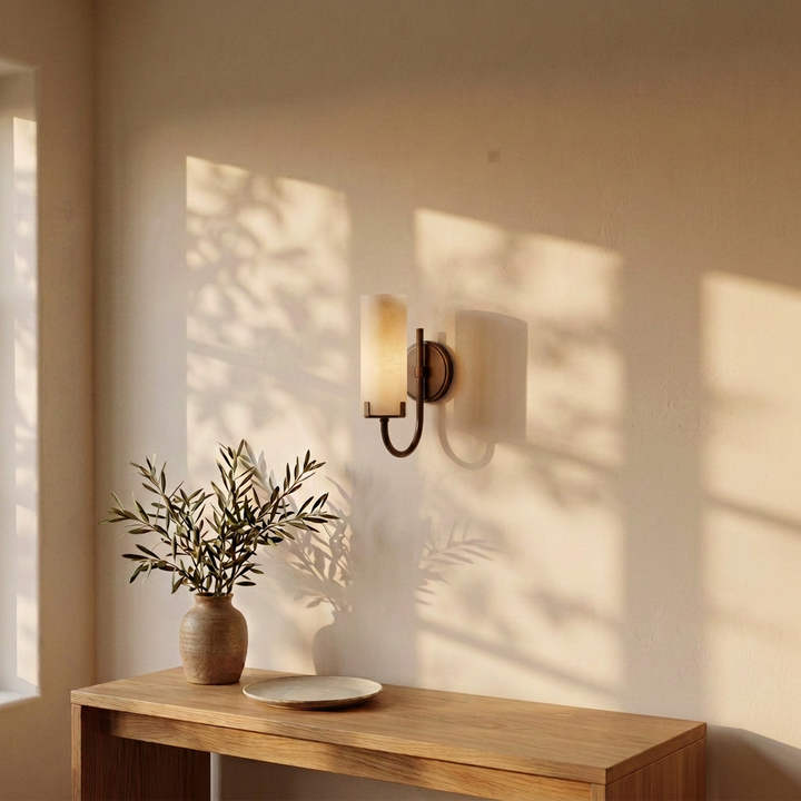 Tessara Loop wall sconce in copper mounted above a console