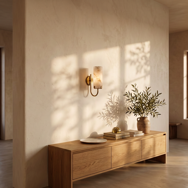 Tessara Loop wall sconce in copper above an oak console