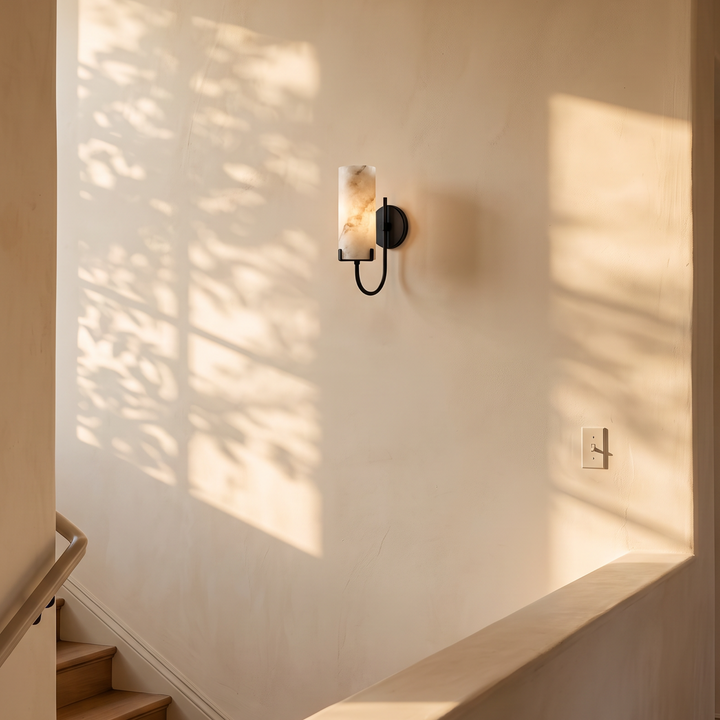 Tessara Loop wall sconce in black on a stair landing