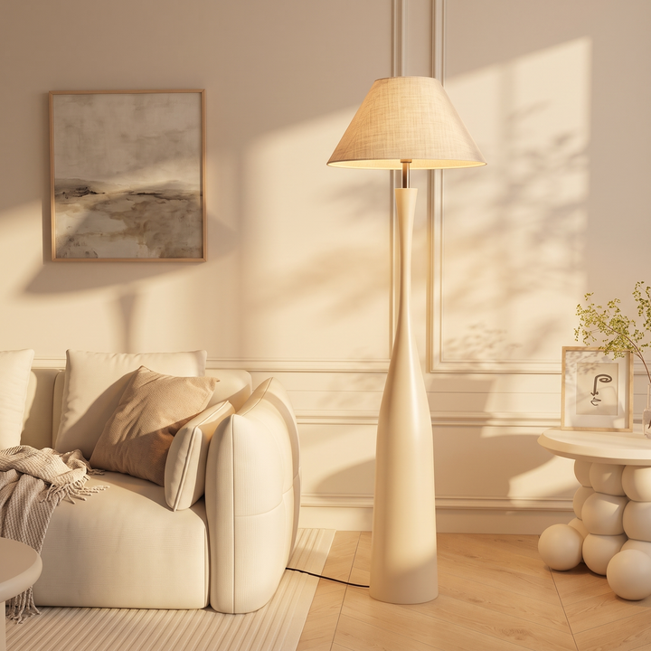Morella beige floor lamp with 21.7 inch shade beside a long sofa