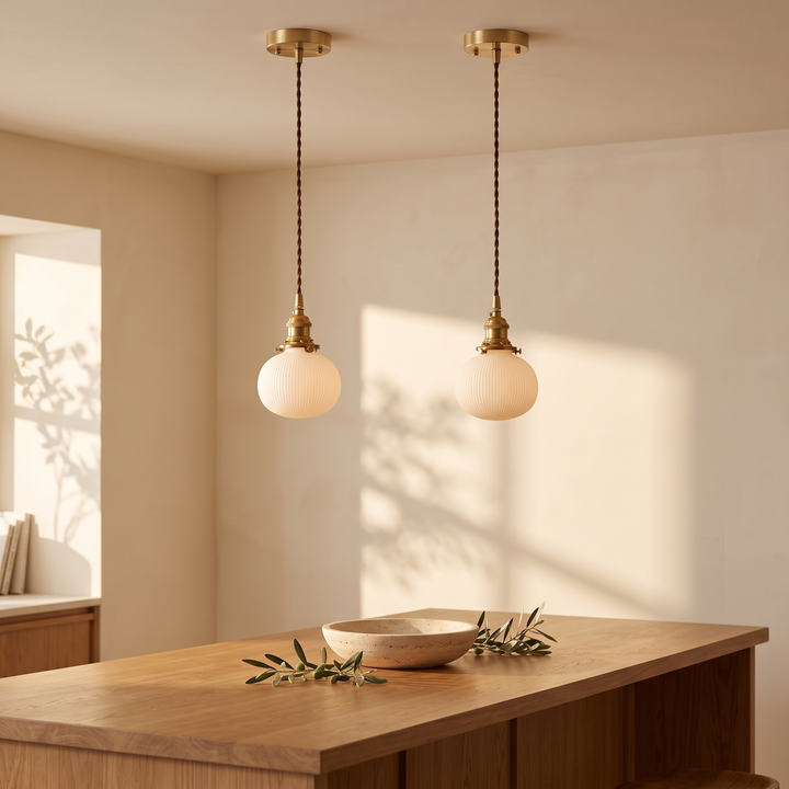 A pair of Bellora Globe ceramic pendant lights above an oak kitchen island