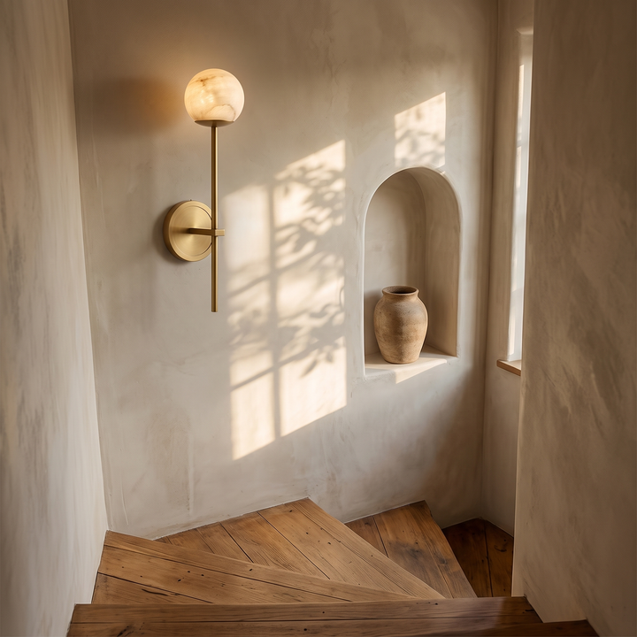 Orbella Long Arm with the 3.9 in marble sphere in gold on a stair landing