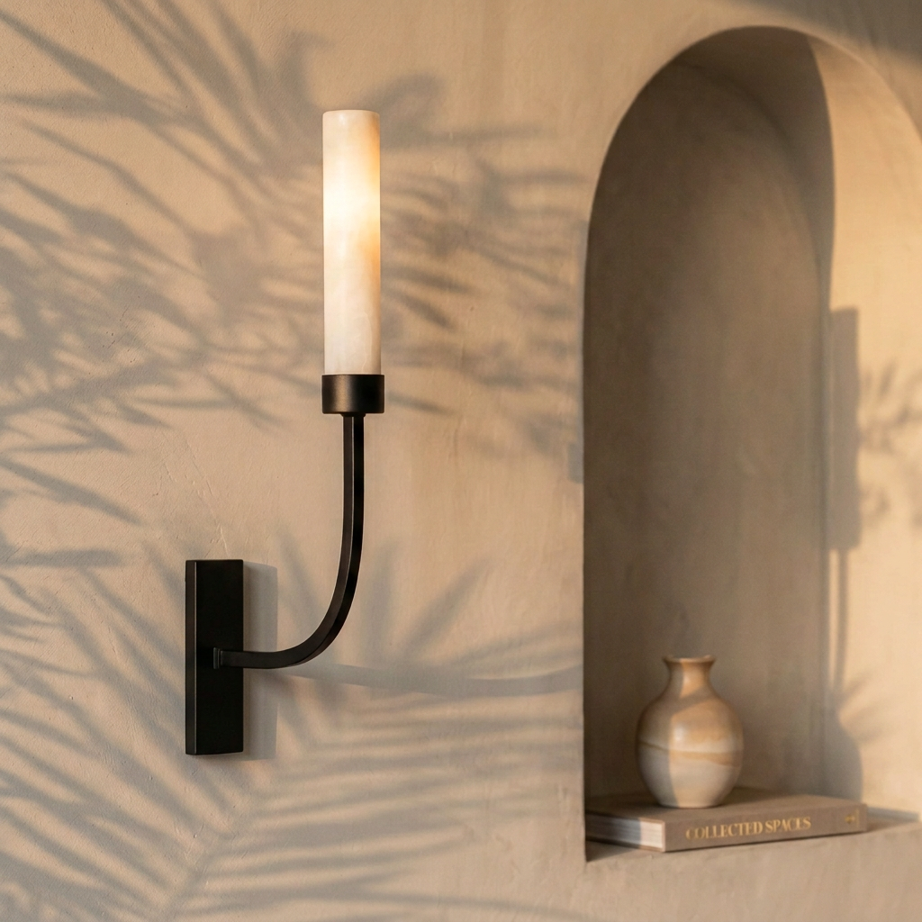 Tessara Column wall sconce in black beside an arched niche
