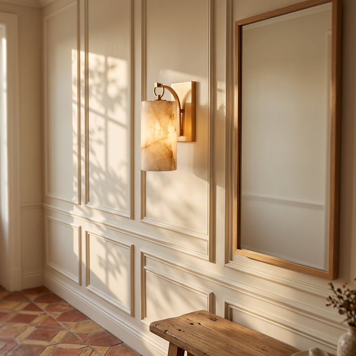 Tessara Lantern marble wall sconce in copper beside a framed mirror
