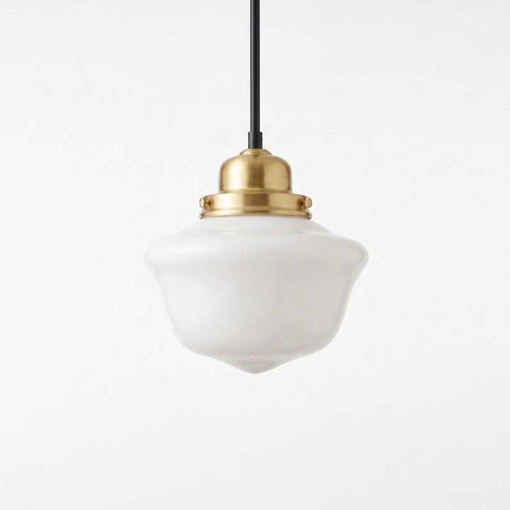 Vika Rounded milk glass schoolhouse pendant light on a brass fitting, on a white studio background
