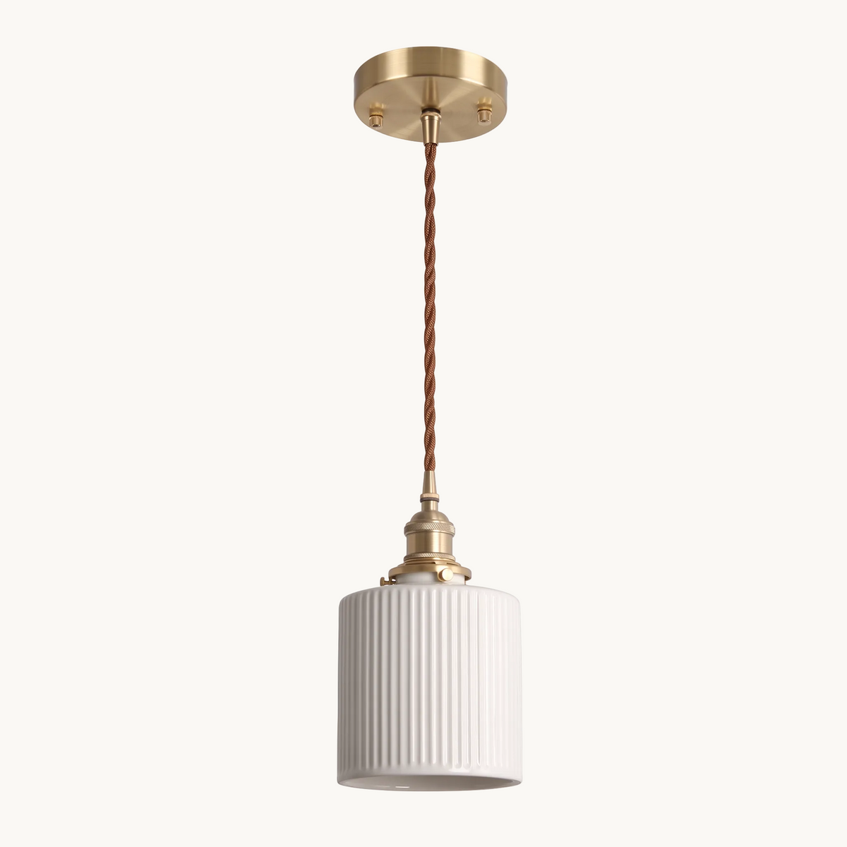 Bellora Cylinder ribbed ceramic and brass pendant light on a pure white background