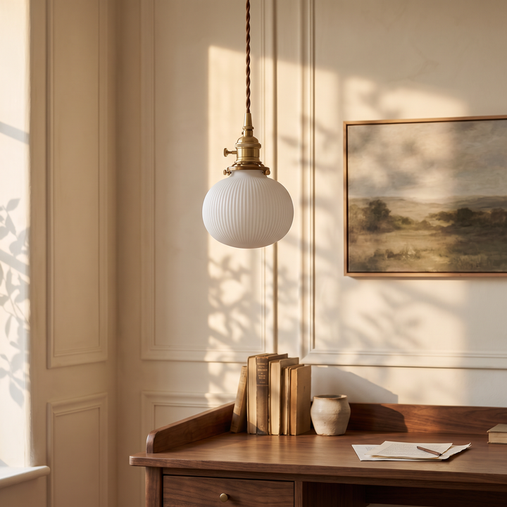 Bellora Globe pendant light above a walnut writing desk in a panelled study