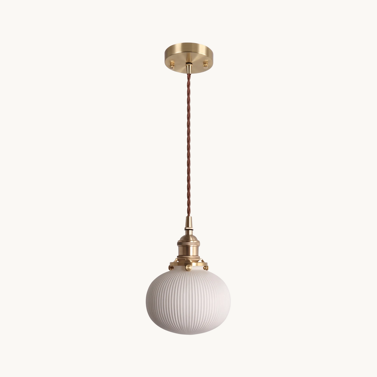 Bellora Globe fluted ceramic and brass pendant light on a pure white background