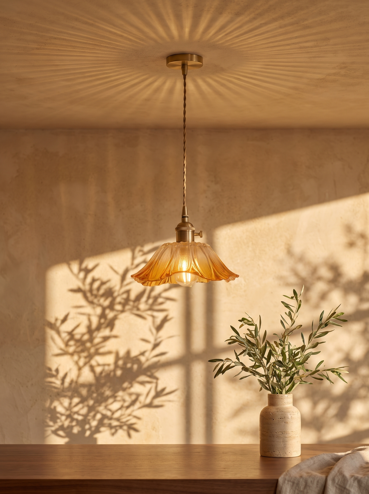 Fiorella pendant in honey amber throwing a patterned wash on a dining room ceiling