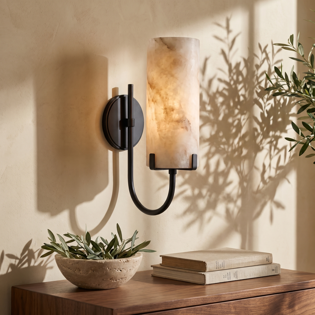 Tessara Loop curved arm marble wall sconce in black above a walnut writing desk
