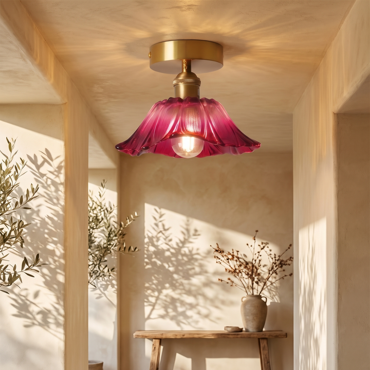 Fiorella flush mount petal glass ceiling light in dusty mauve, lit in a sunlit hallway