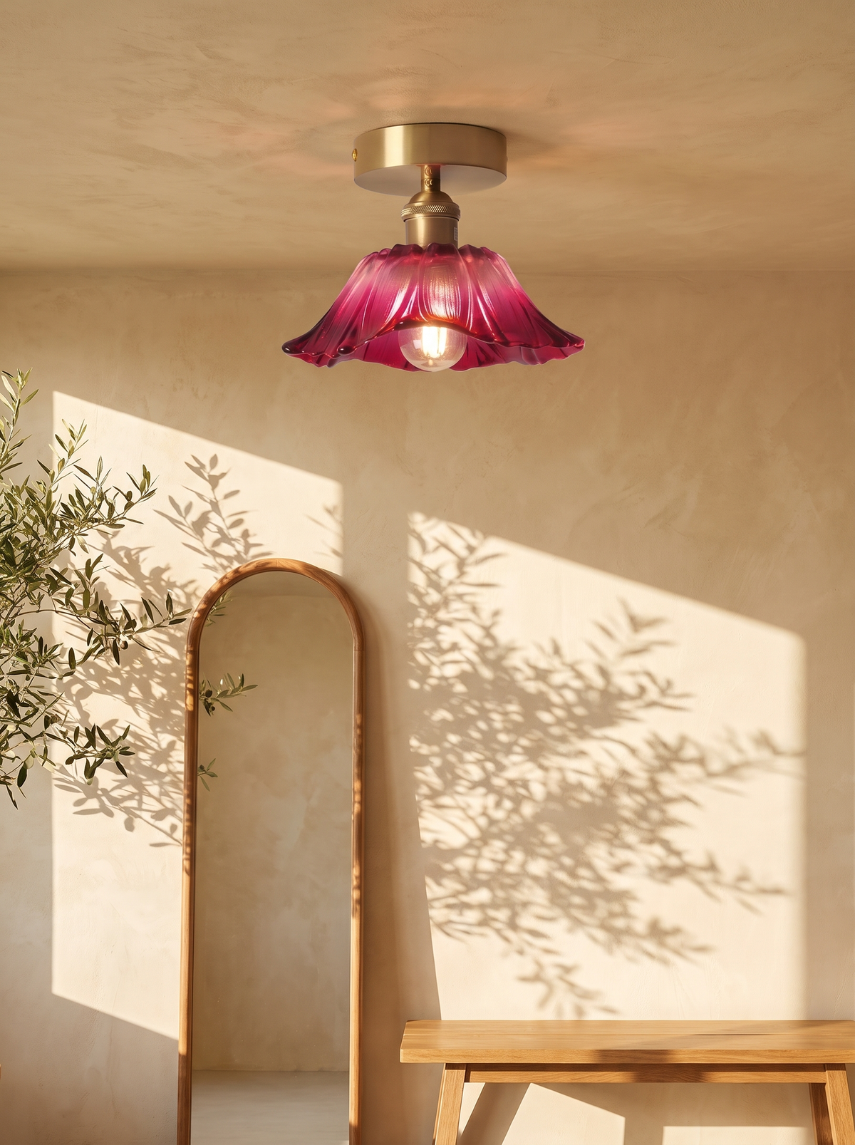 Fiorella flush mount in dusty mauve above an arched mirror