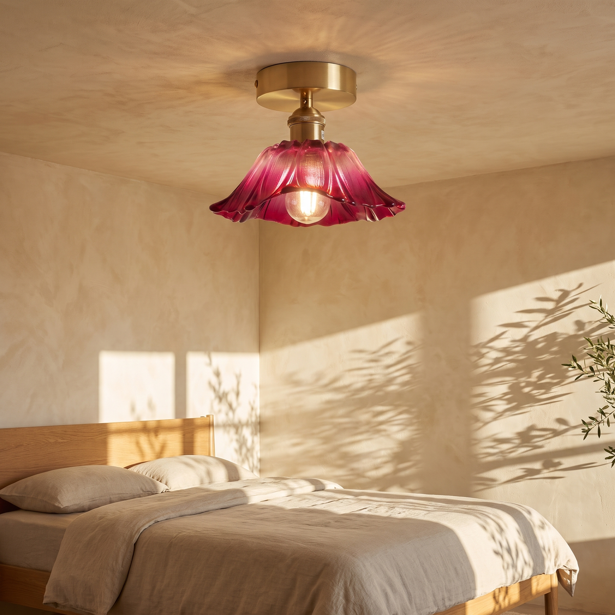 Fiorella flush mount petal glass ceiling light in dusty mauve above a linen dressed bed